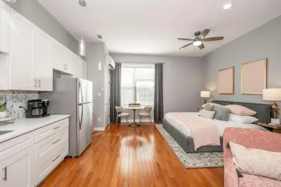 a large bedroom with a bed and a kitchen at Findlay Market - Suite 5 for 2 in Cincinnati