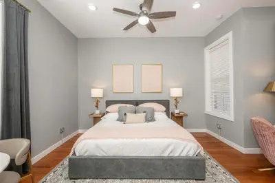 a bedroom with a bed and a ceiling fan at Findlay Market - Suite 5 for 2 in Cincinnati