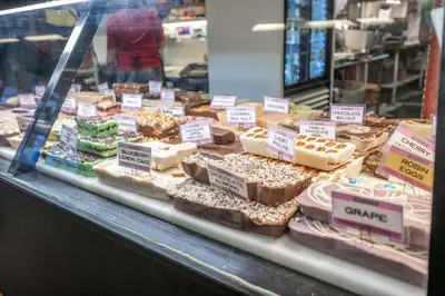 a display case in a bakery with different types of cakes at Findlay Market - Suite 5 for 2 in Cincinnati