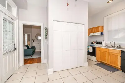 a kitchen with a sliding door leading into a living room at Hackberry Retreat 1 Close to Downtown in Cincinnati