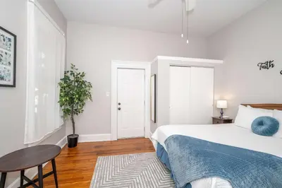 a white bedroom with a bed and a table at Hackberry Retreat 1 Close to Downtown in Cincinnati