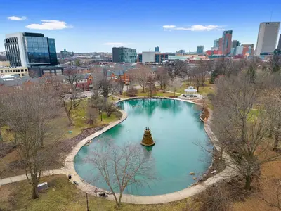a large pool of water with a city in the background at The Luxe Pearl Residences in Columbus