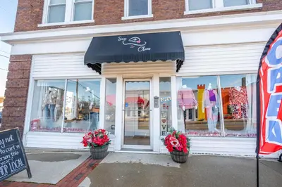 a store front with two potted plants in front of it at Arkstone Retreat 1 - Chic Downtown Escape in Williamstown