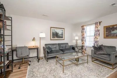 a living room with a couch and two chairs at Arkstone Retreat 1 - Chic Downtown Escape in Williamstown
