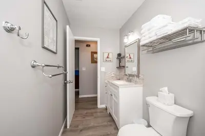 a white bathroom with a toilet and a sink at Arkstone Retreat 3 in Williamstown
