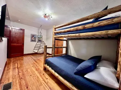 a bedroom with a wooden bunk bed with blue pillows at Mill Haus in South Bloomingville