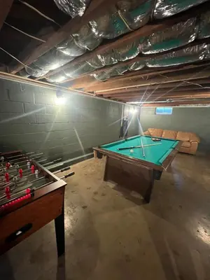 a ping pong table in a room with a pool table at Mill Haus in South Bloomingville