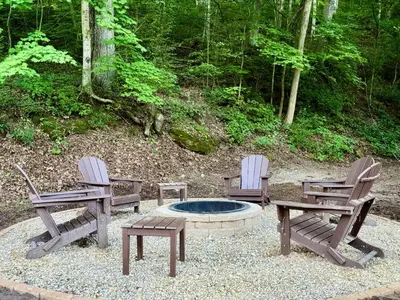 a group of three chairs and a fire pit with a table and two chairs at Mill Haus in South Bloomingville