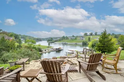 a group of chairs sitting on a patio overlooking a river at Lazy Days Waterfront for 12 in Williamstown