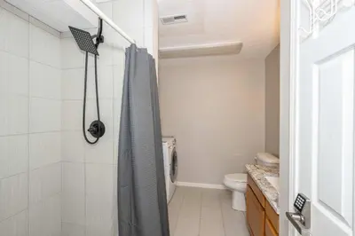 a bathroom with a shower and a toilet at Lazy Days Waterfront for 12 in Williamstown