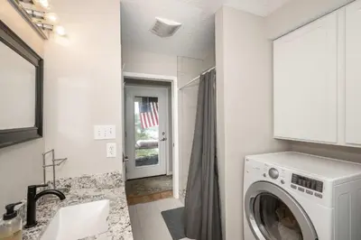 a white laundry room with a washer and dryer at Lazy Days Waterfront for 12 in Williamstown
