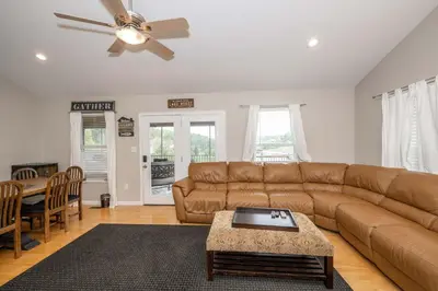 a living room with a couch and a table at Lazy Days Waterfront for 12 in Williamstown