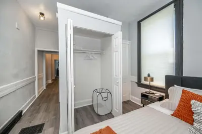 a bedroom with a large mirror next to a bed at Chic Modern Gem with Style in Cincinnati