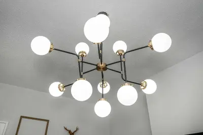 a chandelier hanging from a ceiling in a room at Chic Modern Gem with Style Suites in Cincinnati