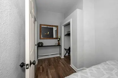 a hallway with a room with a bed and a mirror at Stylish Modern Gem in the HIlls in Cincinnati