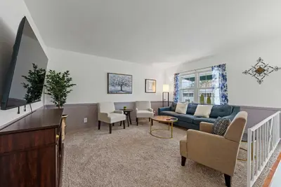 a living room with a couch and a table at The Gahanna Getaway in Columbus