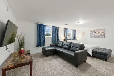 a living room with a couch and a bed at The Gahanna Getaway in Columbus