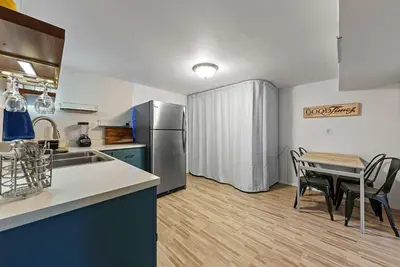 a kitchen and dining room with a table and a refrigerator at The Gahanna Getaway in Columbus