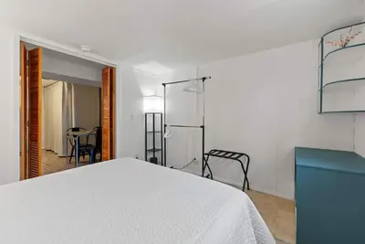 a bedroom with a white bed and a blue cabinet at The Gahanna Getaway in Columbus