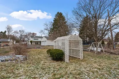 a white cage sitting in the middle of a yard at The Gahanna Getaway in Columbus