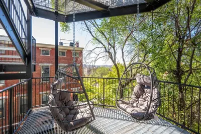 two swings on the balcony of a house at Queen City Views Suites in Cincinnati