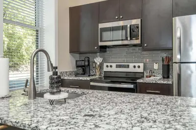 a kitchen with stainless steel appliances and a marble counter top at Queen City Views 2 Sleeps 2 in Cincinnati