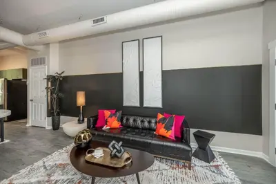 a living room with a black couch and a table at Queen City Views 2 Sleeps 2 in Cincinnati