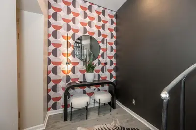 a hallway with a mirror and a table and chairs at Queen City Views 1 Chic 1 BDR in Cincinnati