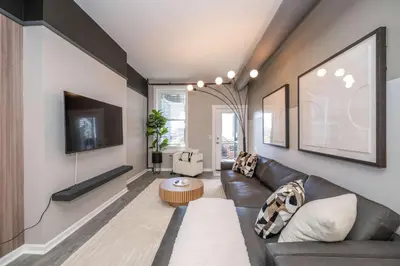 a living room with a couch and a table at Queen City Views 3 Chic 2 BDR in Cincinnati