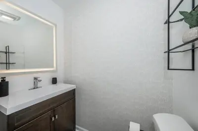 a bathroom with a sink and a mirror at Queen City Views 3 Chic 2 BDR in Cincinnati