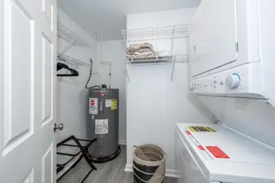 a small white kitchen with a gas stove in it at Queen City Views 3 Chic 2 BDR in Cincinnati