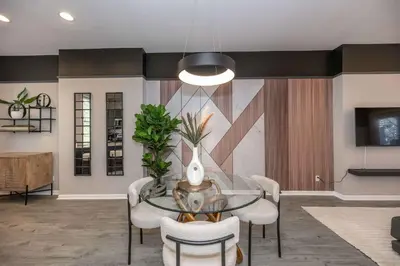 a dining room with a glass table and chairs at Queen City Views 3 Chic 2 BDR in Cincinnati