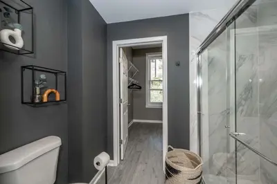 a bathroom with a shower and a toilet at Queen City Views 4 Chic Apt in Cincinnati