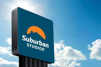 a blue sign for a suburian studios at Suburban Studios Charleston - Civic Center in Charleston