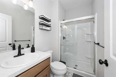 a bathroom with a toilet and a sink and a shower at Lunar Haven - Gorgeous 5 BDR in Walton