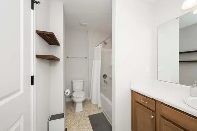 a white bathroom with a toilet and a sink at Lunar Haven - Gorgeous 5 BDR in Walton