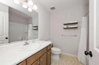 a white bathroom with a sink and a toilet at Lunar Haven - Gorgeous 5 BDR in Walton