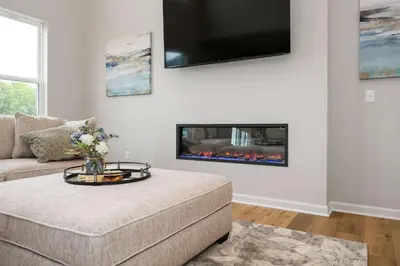 a living room with a couch and a fireplace at Lunar Haven - Gorgeous 5 BDR in Walton