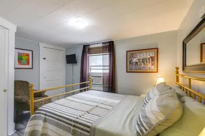 a small bedroom with a bed and a window at 3 Mi to Dtwn Dog-Friendly Retreat in Dayton in Dayton