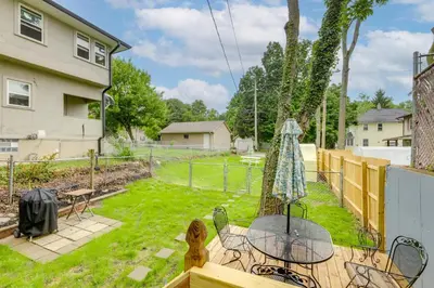 a backyard with a table and chairs and a fence at 3 Mi to Dtwn Dog-Friendly Retreat in Dayton in Dayton