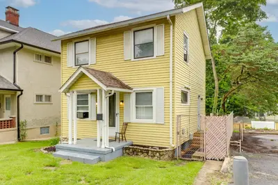 a yellow house with a porch at 3 Mi to Dtwn Dog-Friendly Retreat in Dayton in Dayton