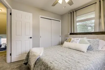a bedroom with a bed and a window and a door at 10 Mi to Dtwn Cincinnati Home with Patio and Yard! in Cincinnati