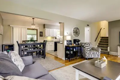 a living room and kitchen with a couch and a table at 10 Mi to Dtwn Cincinnati Home with Patio and Yard! in Cincinnati