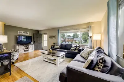 a living room with a couch and a table at 10 Mi to Dtwn Cincinnati Home with Patio and Yard! in Cincinnati