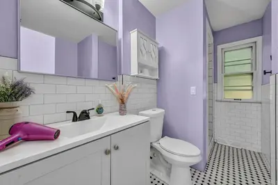 a purple bathroom with a toilet and a sink at Little Paris- In Affluent University HTS in University Heights