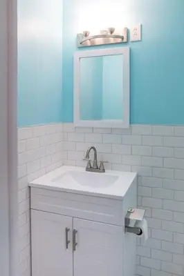 a bathroom with a white sink and a mirror at Little Paris- In Affluent University HTS in University Heights