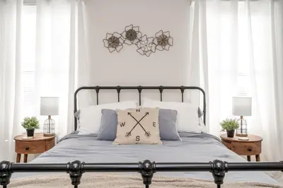 a bedroom with a bed with a clock on it at Historic Ludlow Apt B in Ludlow