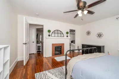 a bedroom with a bed and a fireplace at Historic Ludlow Apt B in Ludlow