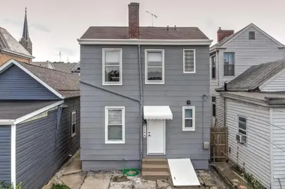 a gray house in a group of houses at Historic Ludlow Apt B in Ludlow