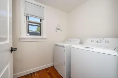 a white laundry room with a washer and dryer at Historic Ludlow Apt B in Ludlow
